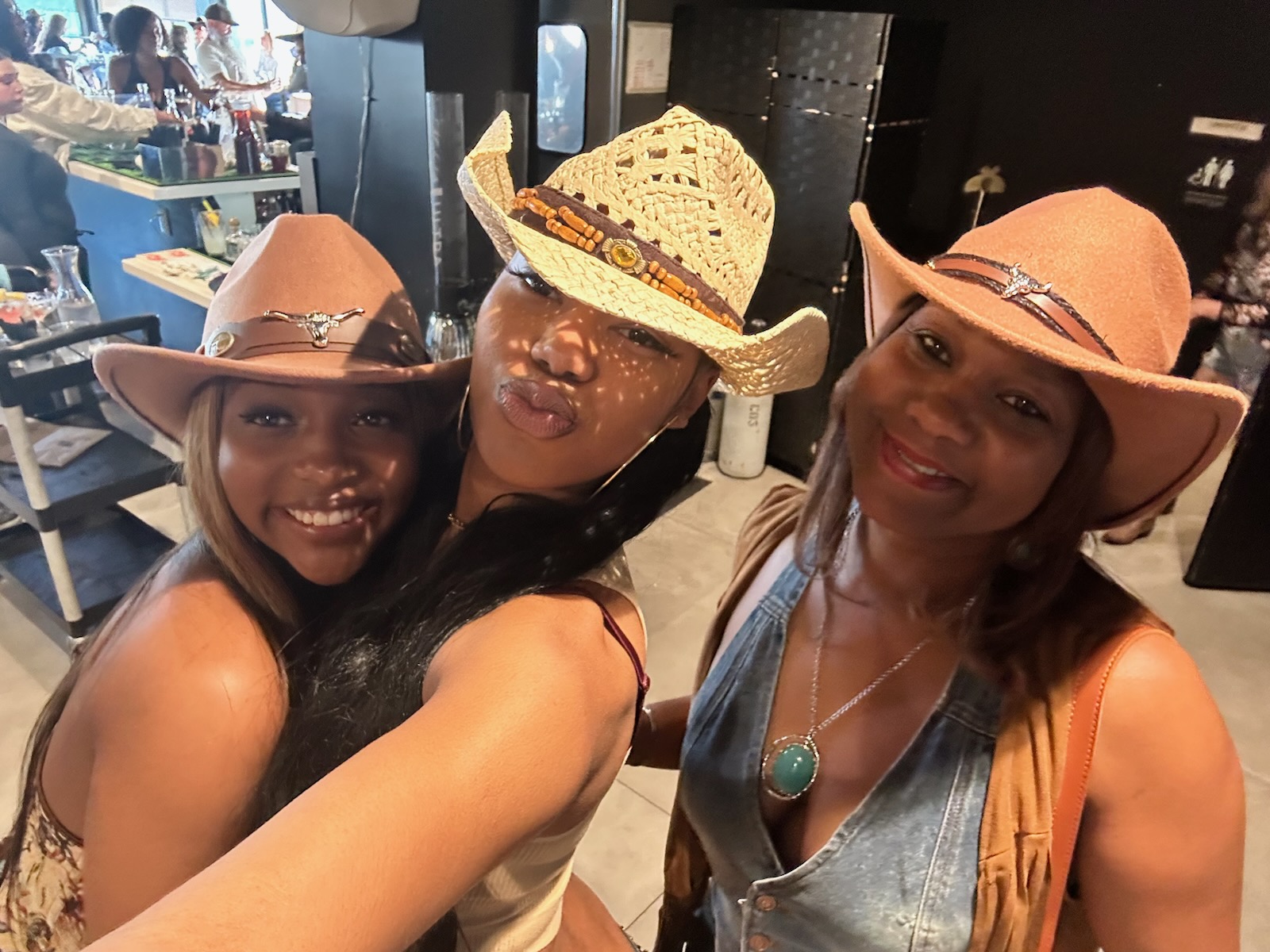 Sherrie celebrating with her girls in cowboy hats